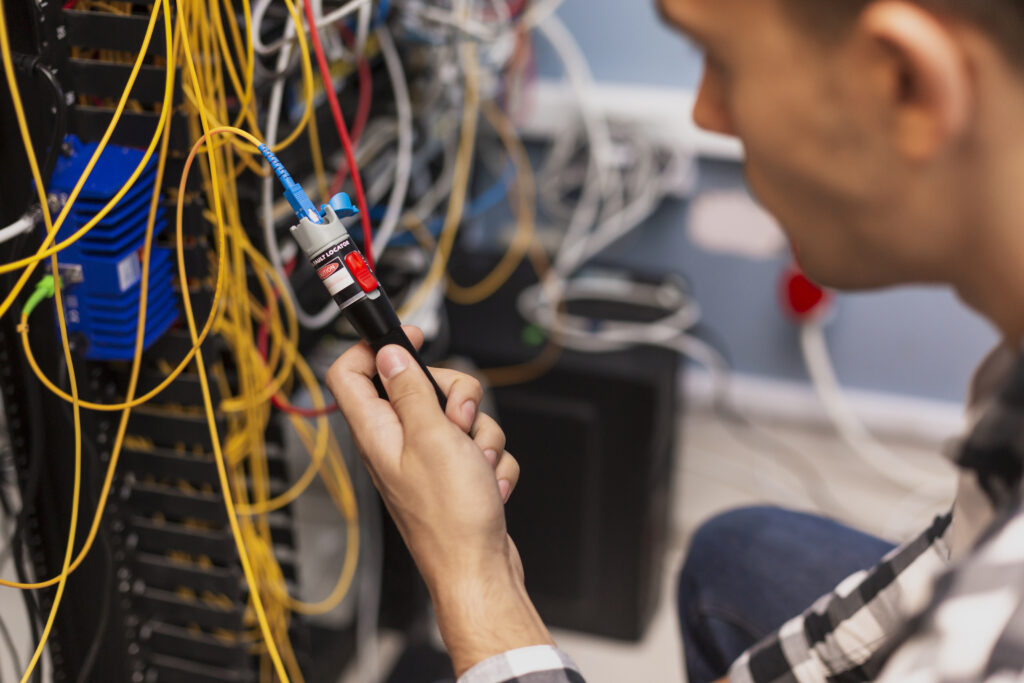 Especialista testando fibra óptica em infraestrutura de rede